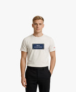 Vue de face d’un homme portant un t-shirt classique écru Salut Fred avec motif Rue Duquesne de la collection Rues de France